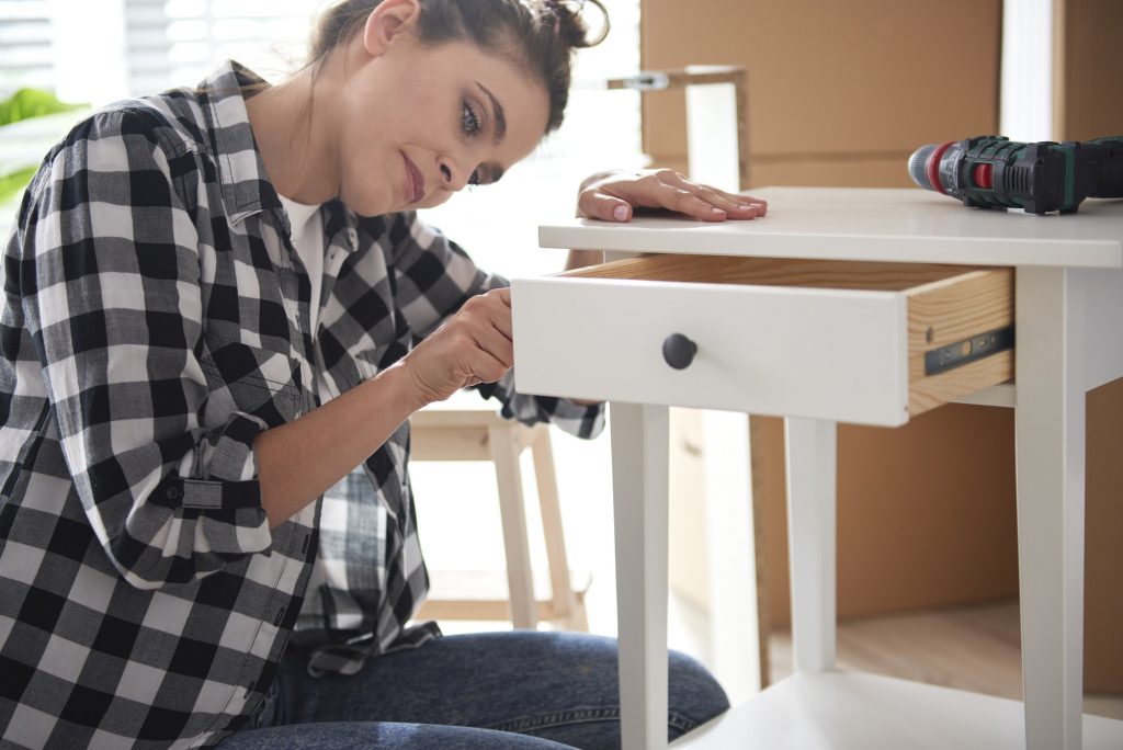 Young woman renovating a night table